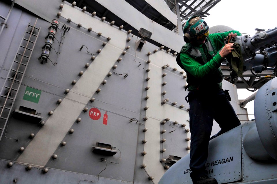US Navy 110710-N-EE987-370 Aviation Machinist's Mate 2nd Class Brandon Rucker, from San Diego, performs routine maintenance on an SH-60F Sea Hawk