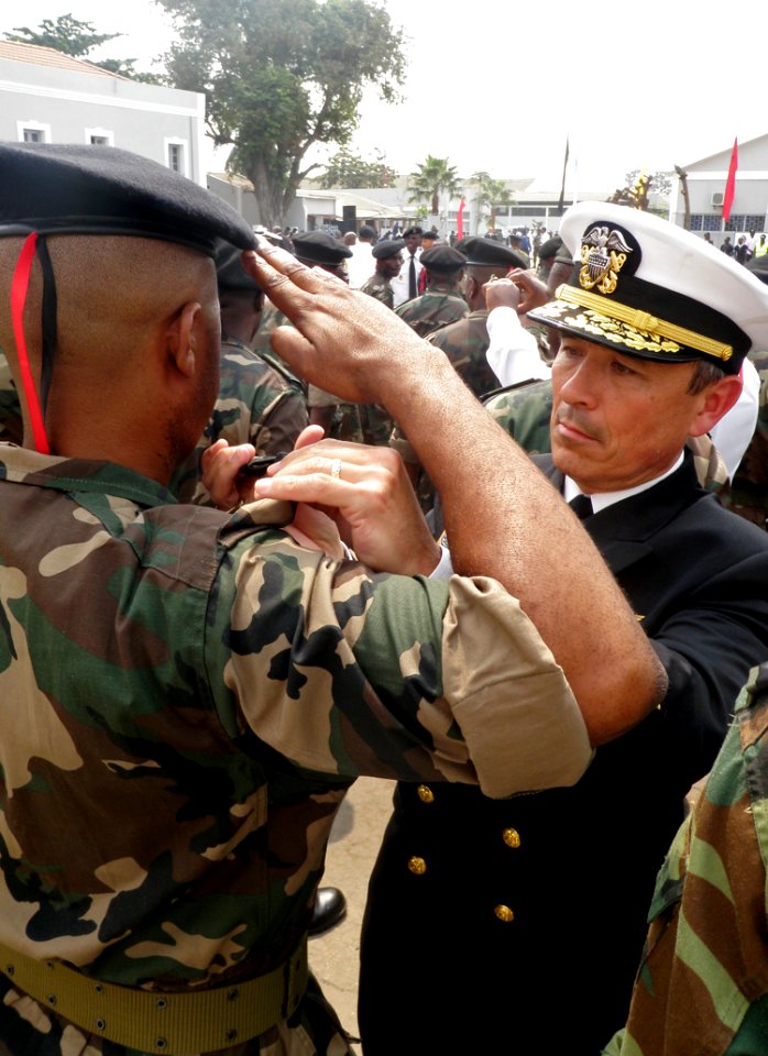 US Navy 110710-N-ZZ000-003 Vice Adm. Harry B. Harris Jr. places new shoulder boards on an Angolan marine during a promotion ceremony to the rank of