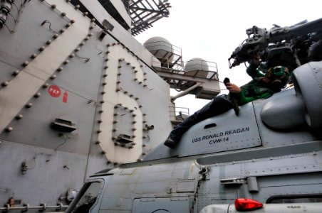 US Navy 110710-N-EE987-389 Aviation Machinist's Mate 2nd Class Brandon Rucker, from San Diego, performs daily maintenance on an SH-60F Sea Hawk hel