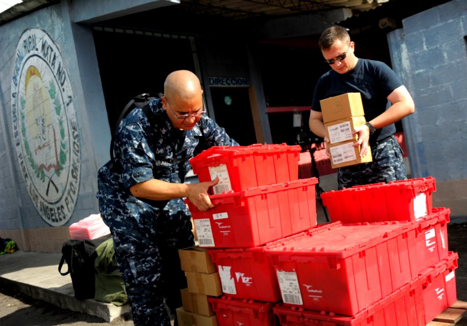 US Navy 110707-N-RM525-076 Hospital Corpsman 1st Class Javier Hinojas, left, and Hospital Corpsman 2nd Class Kenneth Yearout place containers of ph
