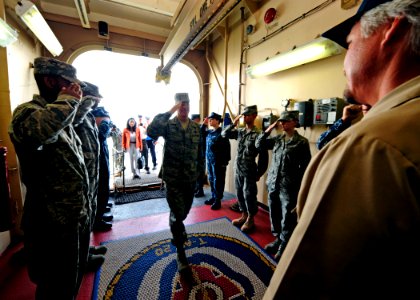 US Navy 110707-N-EP471-001 Air Force Gen. Douglas Fraser salutes civilian Master Capt. Randall Rockwood, assigned to the Military Sealift Commmand