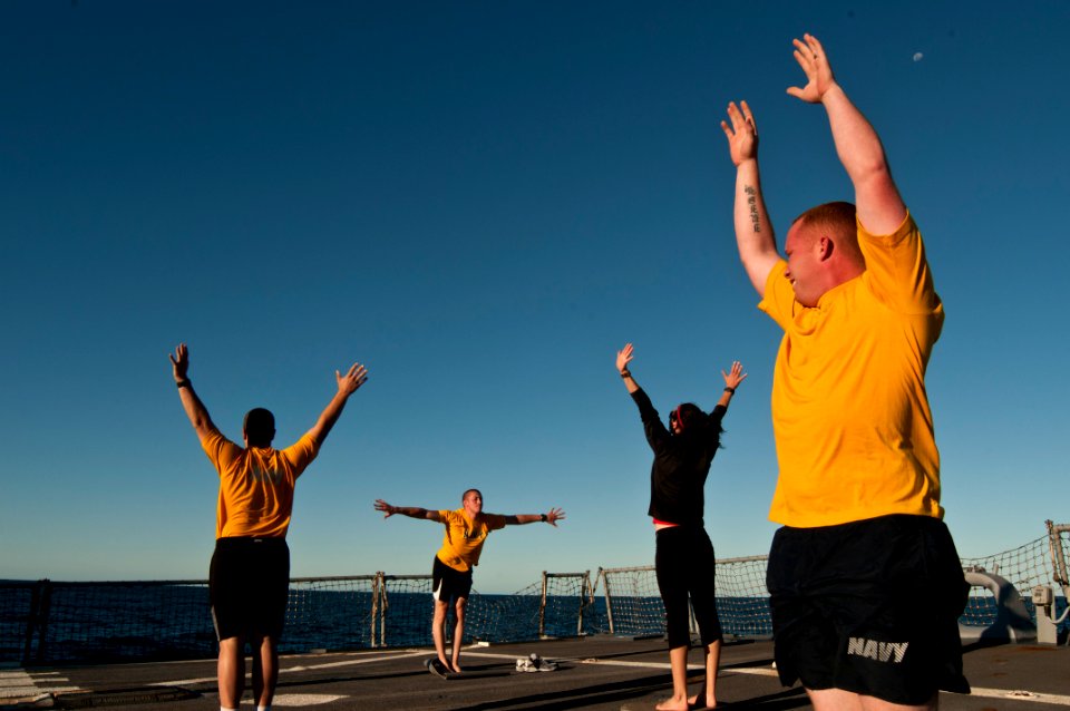 US Navy 110711-N-EA192-163 Sailors practice yoga on the flight deck as a new way to stay physically fit aboard USS Fitzgerald (DDG 62)