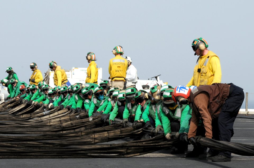 US Navy 110706-N-QL471-133 Sailors set up an emergency barricade during flight deck safety drills aboard the aircraft carrier USS George H.W. Bush