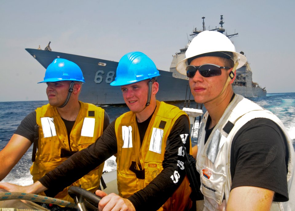 US Navy 110709-N-YM590-051 Sailors guide a rigid-hull inflatable boat past the guided-missile cruiser USS Anzio (CG 68)