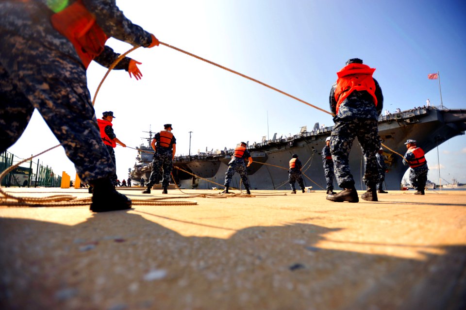 US Navy 110713-N-YR391-080 Sailors assigned to Naval Station Mayport heave a messenger line as the aircraft carrier USS Enterprise (CVN 65)
