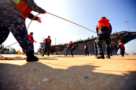 US Navy 110713-N-YR391-080 Sailors assigned to Naval Station Mayport heave a messenger line as the aircraft carrier USS Enterprise (CVN 65)