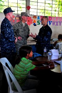 US Navy 110707-F-NJ219-381 Air Force Gen. Douglas Fraser, commander of U.S. Southern Command, listens to Lt. Cmdr. Robert Franks, an optometrist fr