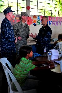 US Navy 110707-F-NJ219-381 Air Force Gen. Douglas Fraser, commander of U.S. Southern Command, listens to Lt. Cmdr. Robert Franks, an optometrist fr photo