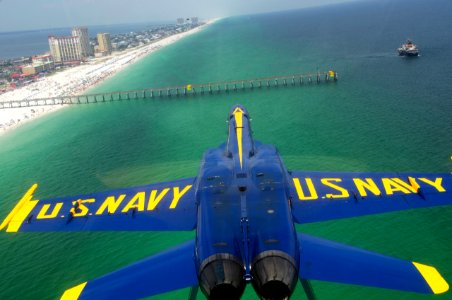 US Navy 110707-N-BA418-065 An F-A-18 Hornet flies inverted over Pensacola Beach while performing the double farvel maneuver during a practice fligh
