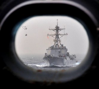 US Navy 110711-N-ZS026-237 A helicopter descends to the flight deck aboard the guided-missile destroyer USS Truxton (DDG 103)