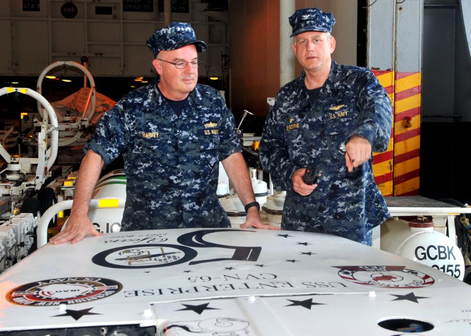 US Navy 110713-N-CH661-240 Adm. John C. Harvey Jr., commander of U.S. Fleet Forces Command, left, listens as Capt. Dee L. Mewbourne, commanding off