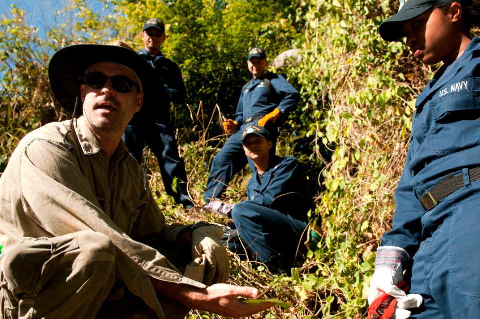 US Navy 110712-N-CZ945-028 Toa Kyle explains the importance of the Macaranga plant in Australia to Sailors