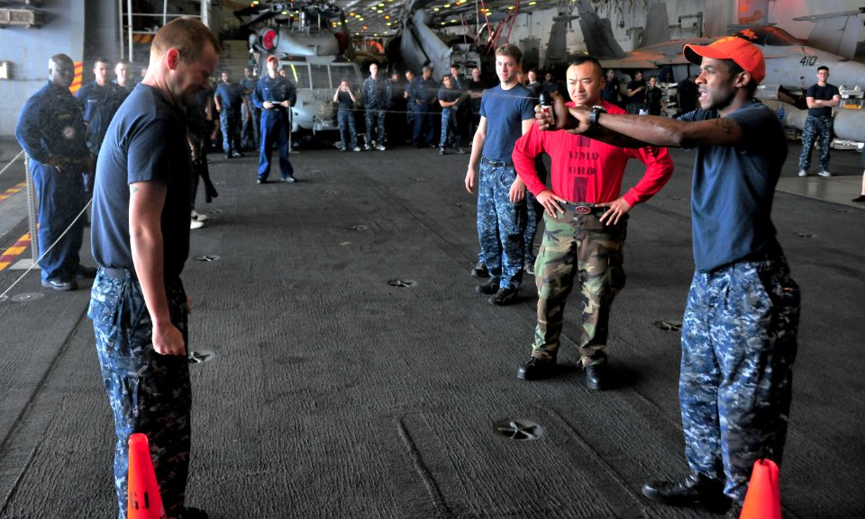 US Navy 110707-N-OP638-041 Quartermaster 3rd Class Jaykob W. Lamb gets sprayed in the face with oleoresin capsicum spray during a security qualific