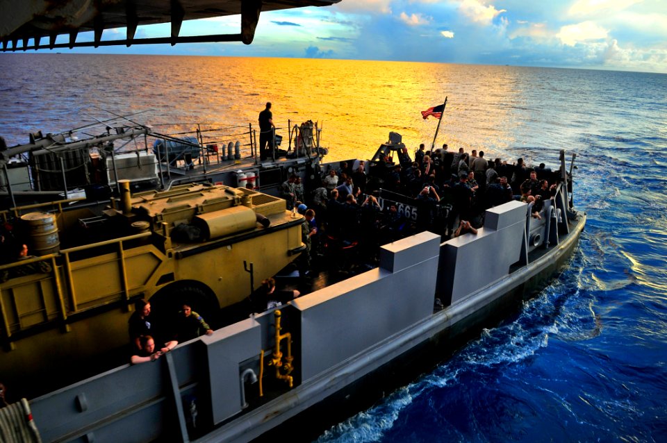 US Navy 110712-N-KB563-015 Military and civilian personnel participating in Pacific Partnership 2011 exit the well deck of the amphibious transport