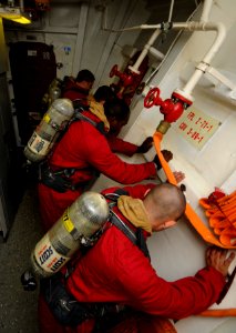US Navy 110708-N-OM642-013 Sailors aboard the guided-missile frigate USS Carr (FFG 52) brace for shock from an incoming missile hit