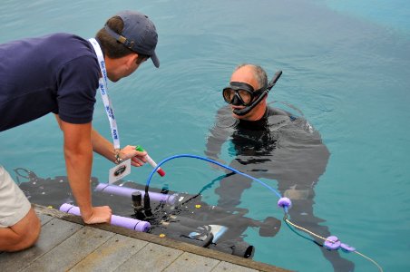 US Navy 110713-N-UN340-006 Space and Naval Warfare Systems Center Pacific diver John Pryor assists University of Florida team member, Patrick Walte