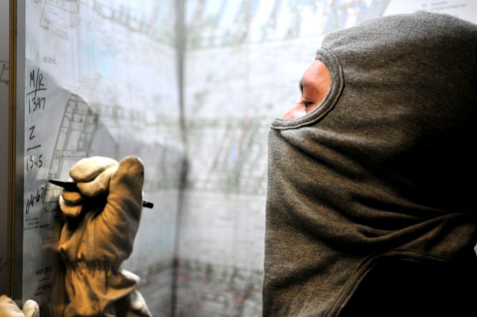 US Navy 110709-N-ZS026-101 Aviation Electronics Technician 3rd Class Dustin Woggerman plots simulated casualty locations during a general quarters