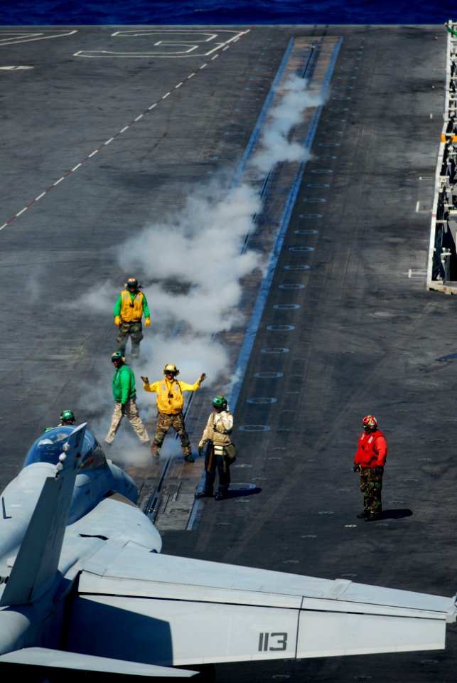 US Navy 110707-N-WW409-318 Sailors direct an F-A-18F Super Hornet assigned to the Diamondbacks of Strike Fighter Squadron (VFA) 102 aboard the air