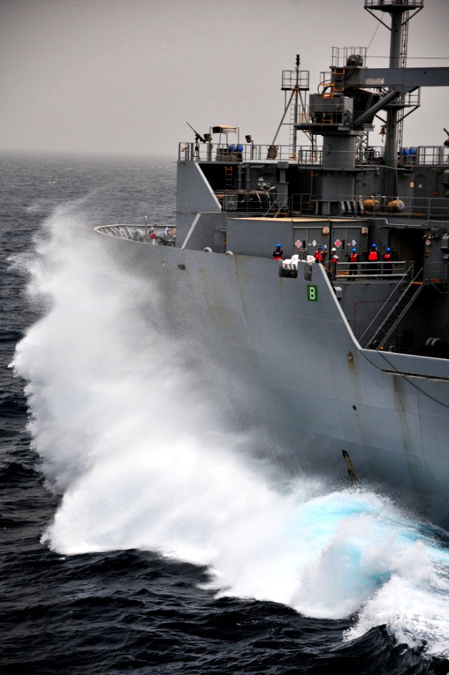 US Navy 110711-N-ZS026-153 Waves crash against the bow of the Military Sealift Command dry cargo and ammunition ship USNS Alan Shepard (T-AKE 3) as