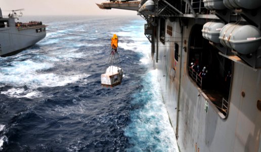 US Navy 110711-N-ZS026-506 The amphibious assault ship USS Boxer (LHD 4) receives pallets of supplies from the Military Sealift Command dry cargo a