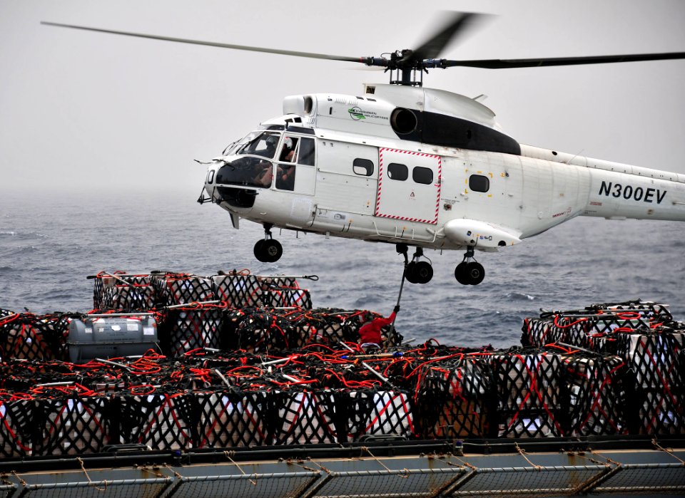 US Navy 110711-N-ZS026-334 A civilian mariner aboard the Military Sealift Command dry cargo and ammunition ship USNS Alan Shepard (T-AKE 3)