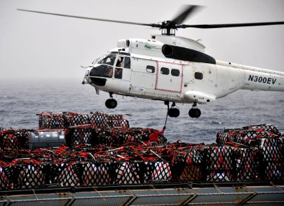 US Navy 110711-N-ZS026-334 A civilian mariner aboard the Military Sealift Command dry cargo and ammunition ship USNS Alan Shepard (T-AKE 3)