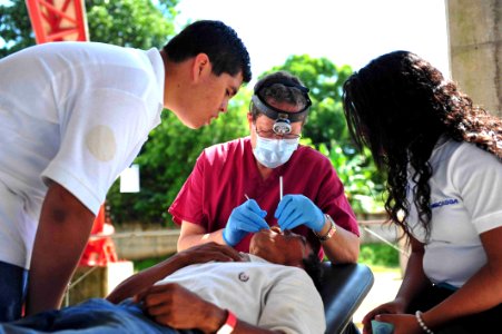 US Navy 110715-F-NJ219-059 Stu Whiddon, a dentist from Greensboro, N.C., cleans a Salvadoran patient's teeth