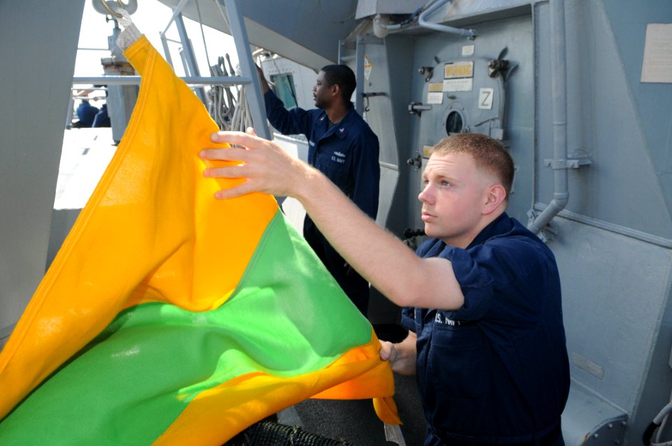 US Navy 110712-N-IO627-012 Quartermaster Seaman Apprentice Shane Langhes raises the prep pennant aboard the guided-missile destroyer USS Curtis Wil