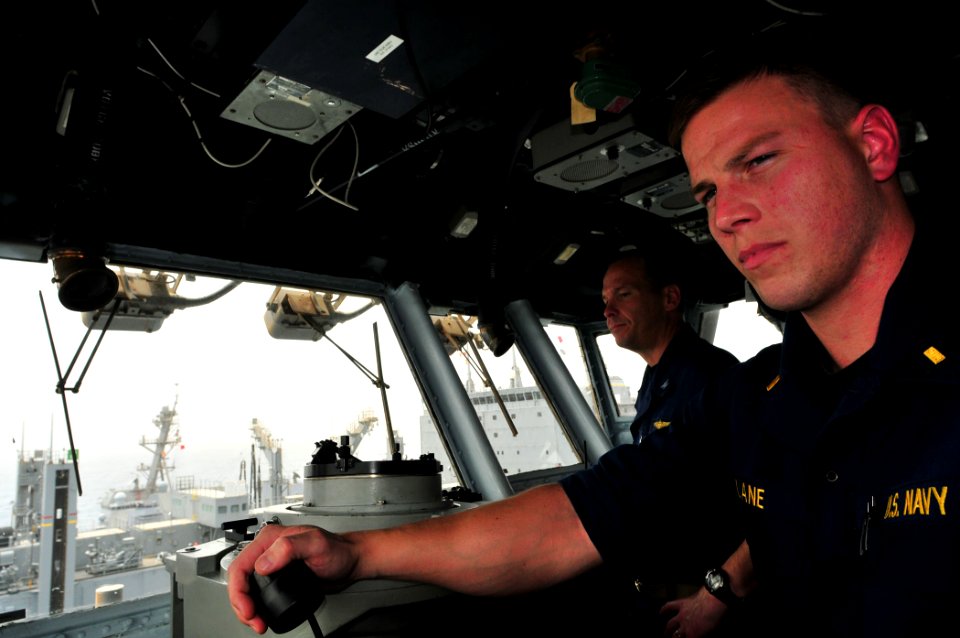US Navy 110711-N-ZS026-471 Capt. Frank Michael and Ensign Alex Lane oversee and direct course and speed changes from the ship's bridge
