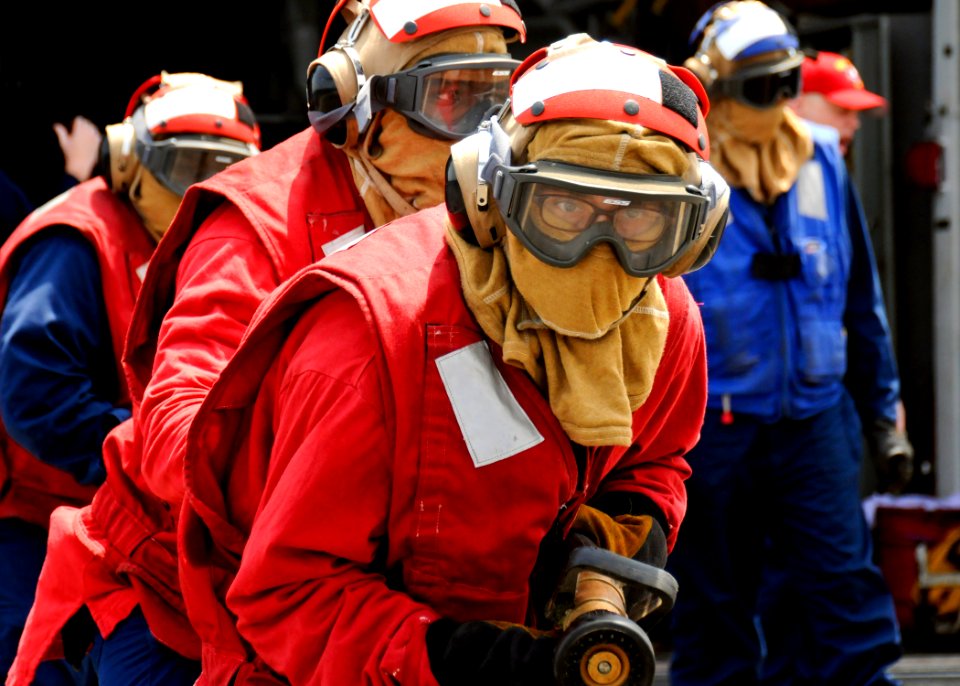 US Navy 110711-N-YM590-008 Sailors approach a simulated fire on the flight deck of the guided-missile cruiser USS Anzio (CG 68) during a flight dec