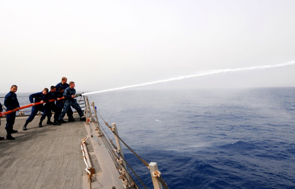US Navy 110713-N-TB177-185 Sailors conduct hose-handling training aboard the guided-missile destroyer USS Truxtun (DDG 103)