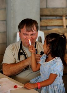 US Navy 110715-N-NY820-363 Maj. William McClung examines a patient during a Continuing Promise 2011 community service medical project at the Polide photo