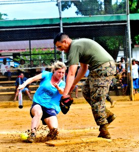 US Navy 110710-N-ZZ999-025 Dr. Lydia Tong makes it to first plate safely during a community service event at the Spanish Wall