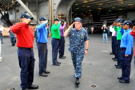 US Navy 110713-N-CH661-248 dm. John C. Harvey Jr., commander of U.S. Fleet Forces Command, salutes rainbow sideboys during a brief visit aboard the