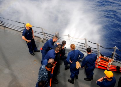 US Navy 110713-N-TB177-115 Sailors conduct hose-handling training aboard the guided-missile destroyer USS Truxtun (DDG 103)