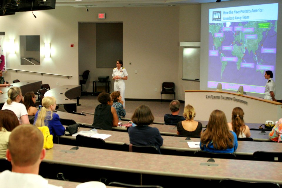 US Navy 110713-N-QE550-023 Rear Adm. Gretchen S. Herbert peaks with young women at an event sponsored by the Society of Women Engineers at RIT Xero
