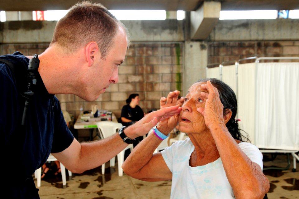 US Navy 110717-N-EP471-275 Lt. j.g. Jerry Brown, from Livermore, Iowa, looks into a Salvadoran woman's eyes as she waits to receive medical care du