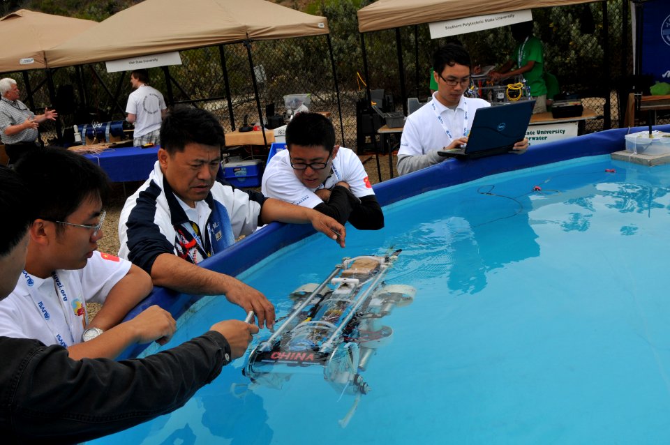 US Navy 110713-N-UN340-037 Students from China's Harbin Engineering University perform in-water checks on their autonomous underwater vehicle durin