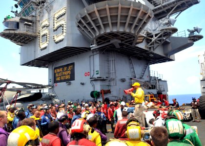 US Navy 110712-N-CH661-003 Lt. j.g. Gilbert L. Bishop briefs members of the air department on firefighting scenarios aboard USS Enterprise (CVN 65)