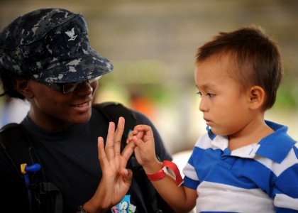 US Navy 110715-N-NY820-340 Hospital Corpsman 3rd Class Chavone Taylor plays with a pediatrics patient during a Continuing Promise 2011 community se photo