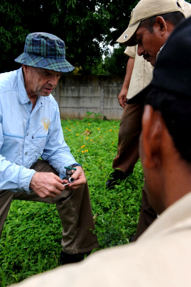 US Navy 110718-F-ET173-135 Kenneth Kartchner, a Latter-day Saints Charities volunteer and civil engineer, from Provo, Utah, talks with Salvadorans