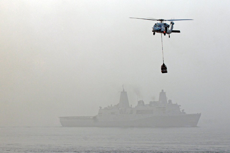 US Navy 110717-N-RC734-184 An MH-60S Sea Hawk helicopter carries supplies from USNS Wally Schirra (T-AKE 8) during a vertical replenishment