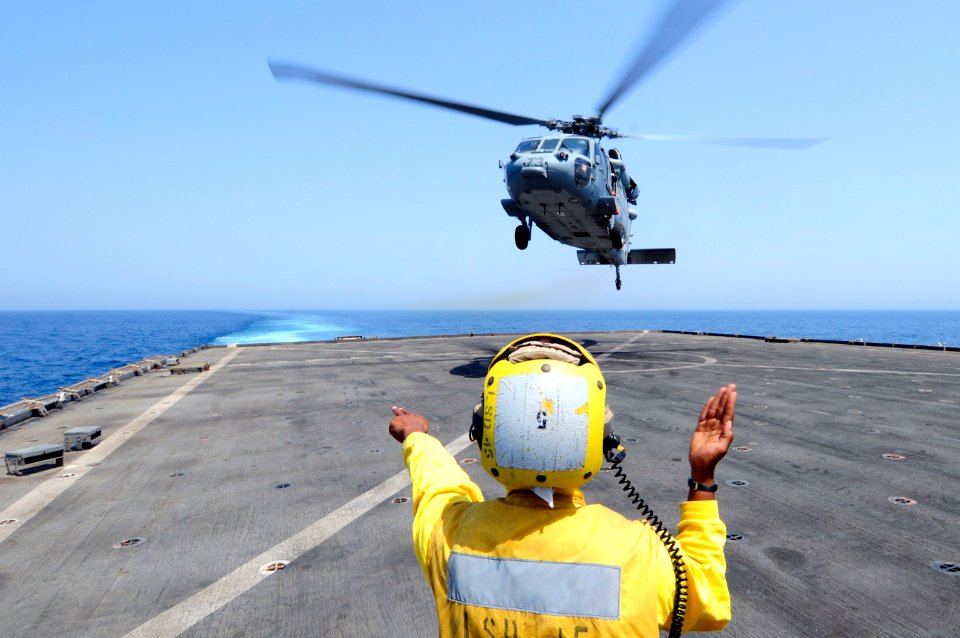 US Navy 110714-N-RC734-090 Boatswain's Mate 3rd Class Leshea Isom launches an MH-60S Sea Hawk helicopter