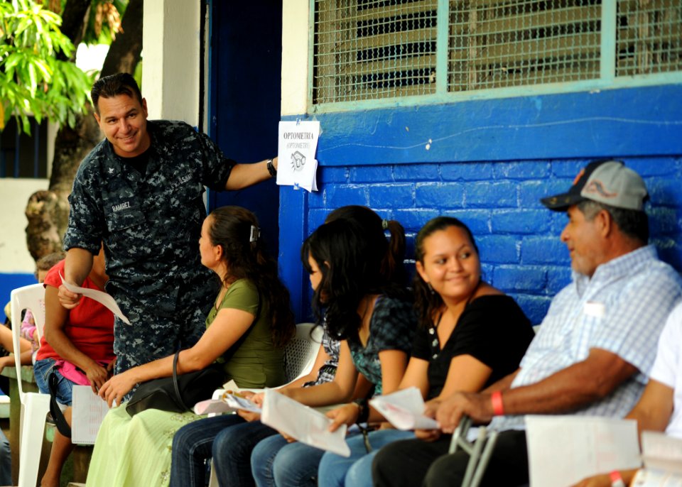 US Navy 110717-N-NY820-191 Hospital Corpsman 3rd Class Ricardo Ramirez, from Colombia, talks with optometry patients during a Continuing Promise 20