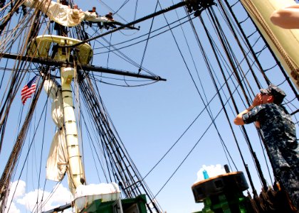 US Navy 110715-N-AU127-353 Aircrew Survival Equipmentman 2nd Class Jason Keith, assigned to USS Constitution, relays orders to furl a sail during s