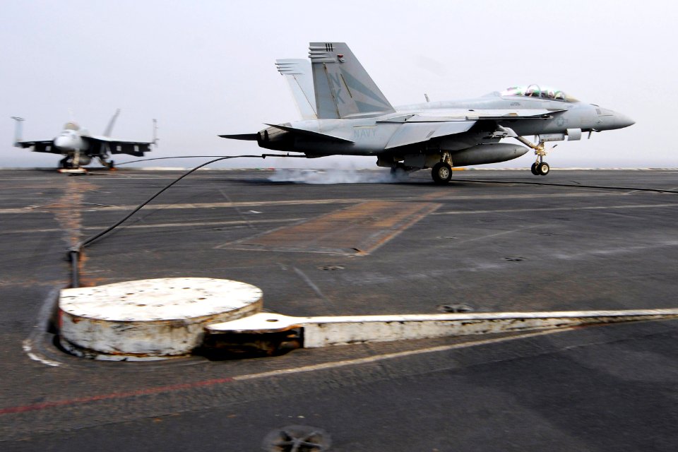 US Navy 110718-N-EE987-120 An F-A-18F Super Hornet assigned to the Black Knights of Strike Fighter Squadron (VFA) 154 lands aboard the aircraft car