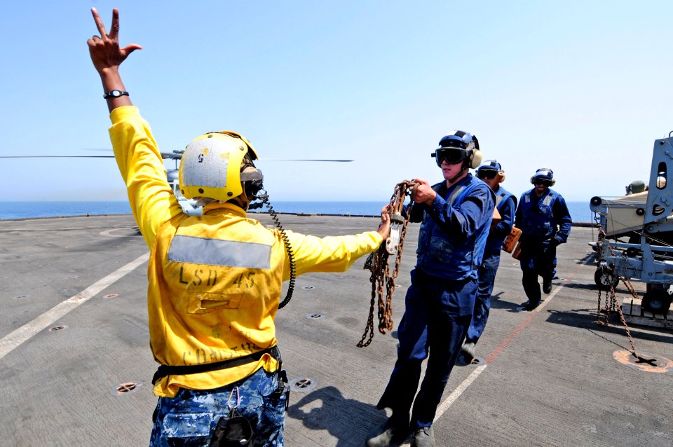 US Navy 110714-N-RC734-078 Boatswain's Mate 3rd Class Leshea Isom, from Newark, N.J., counts the tie-down chains from an MH-60S Sea Hawk helicopter