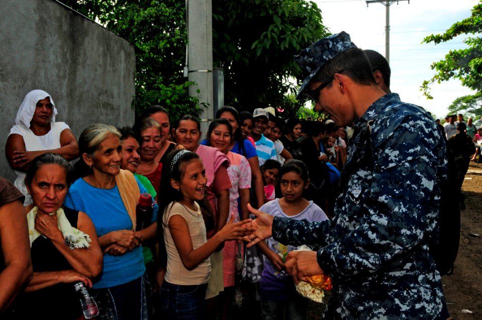 US Navy 110717-N-EP471-087 Hospital Corpsman 2nd Class Ramon Santos, from Visalia, Calif., slaps hands with a Salvadoran child waiting to receive m