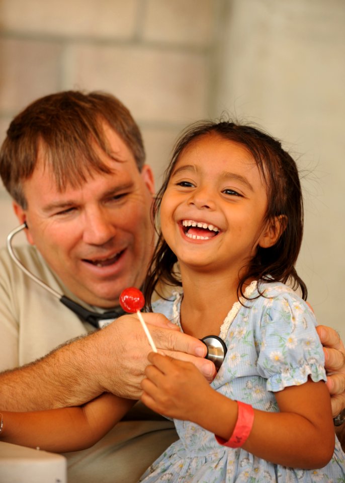 US Navy 110715-N-NY820-351 Maj. William McClung examines a patient during a Continuing Promise 2011 community service medical project at the Polide