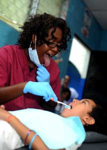 US Navy 110717-N-NY820-066 Hospitalman Brittney Salter, from Pensacola, Fla., performs a dental cleaning during a Continuing Promise 2011 community